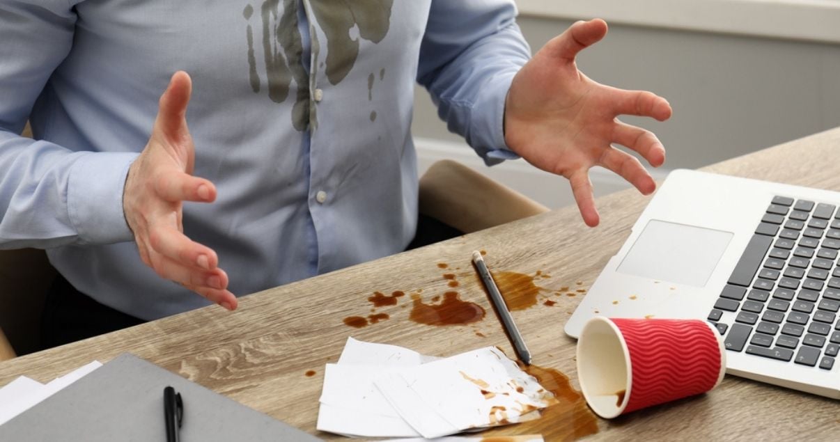 Businessman spilled coffe over work documents